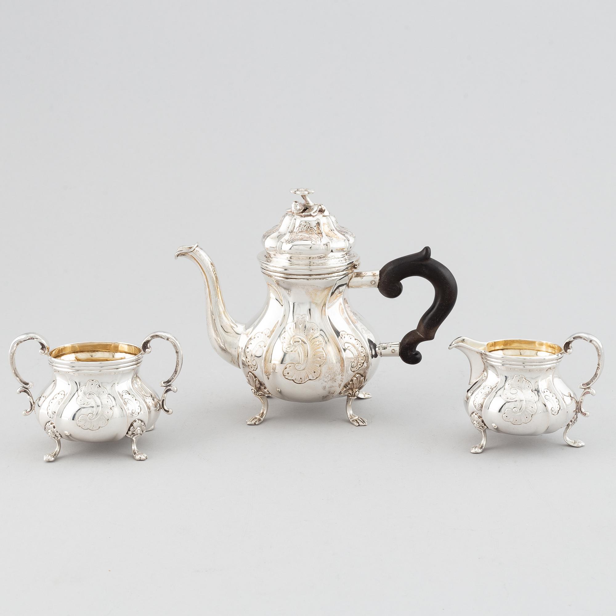 An early 20th century Rococo-style parcel gilt and silver three part coffee service.