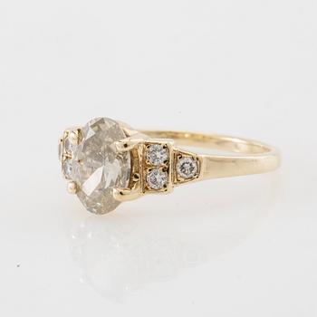 Ring 14K gold with an oval faceted diamond approximately 1.23 ct and round brilliant-cut diamonds.