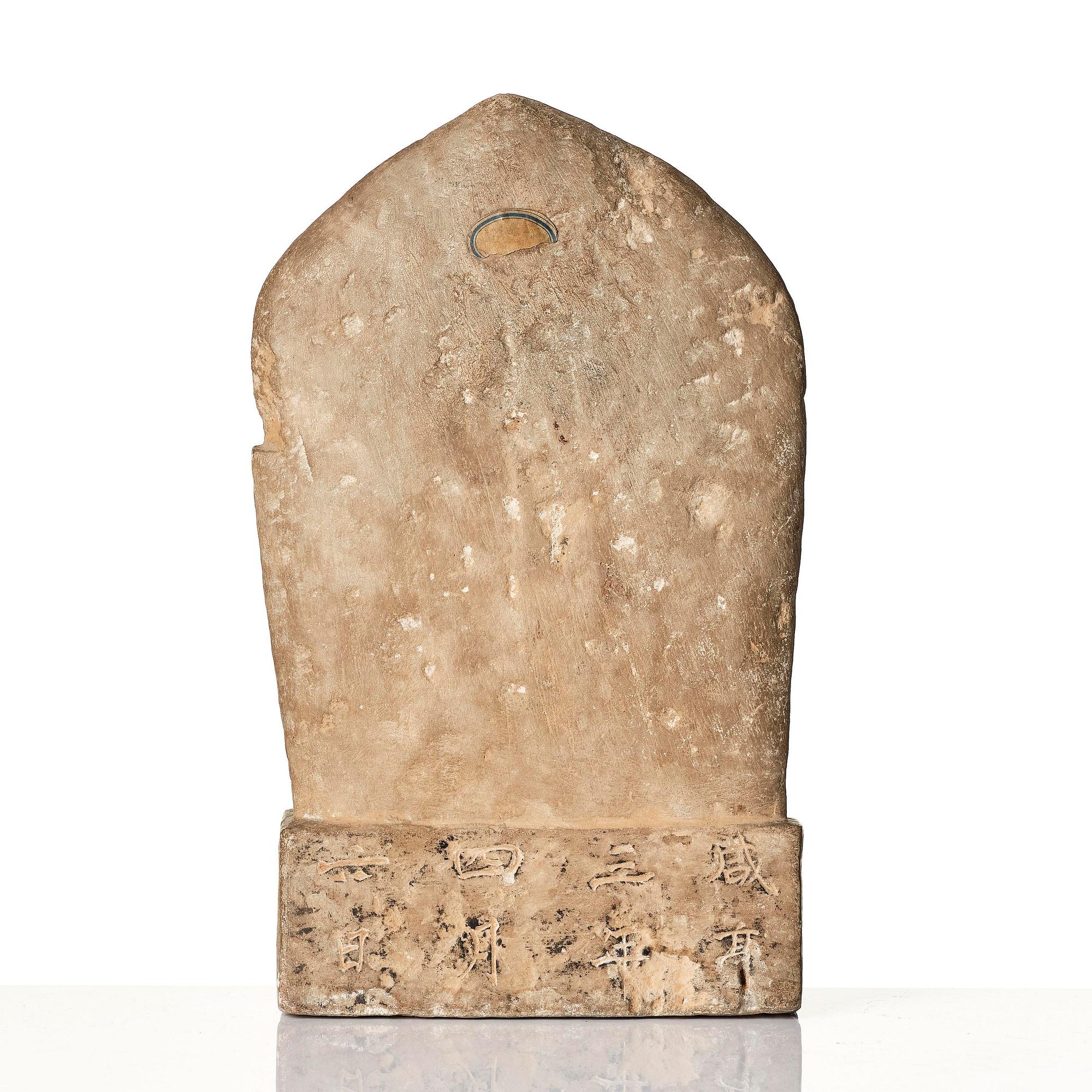 An inscribed limestone Buddhist stele, Tang style, with an inscription the third year of the Xian, corresponding to 672.