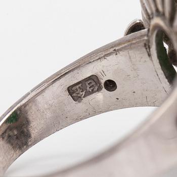 A palladium-plated silver ring with cabochon-cut jadeite and diamonds.