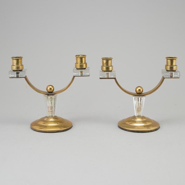 A pair of art déco brass and glass candelabra.