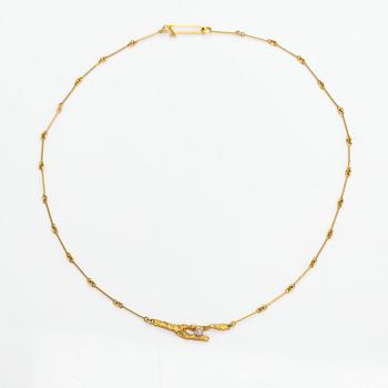 Björn Weckström, An 18K gold necklace "Diamond bud" with a ca. 0.02 tc diamond. Lapponia 1982.