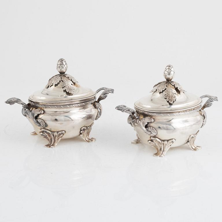 A pair of Swedish Rococo style sterling silver sauce tureens with lid and spoons, mark of Wiwen Nilsson, Lund 1947-1948.