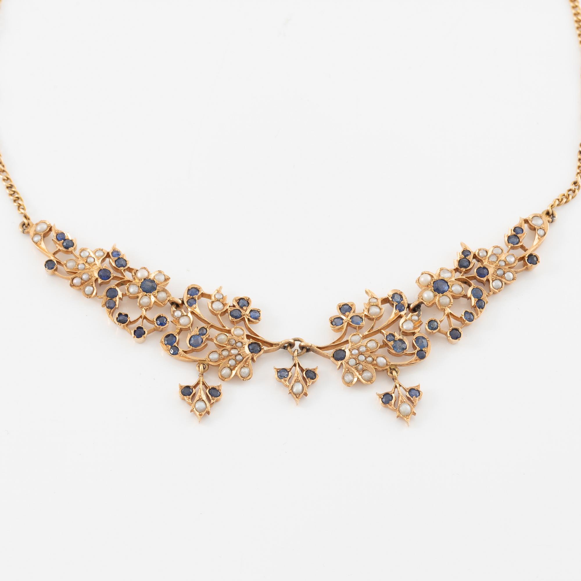 A 14K gold necklace with sapphires and pearls.