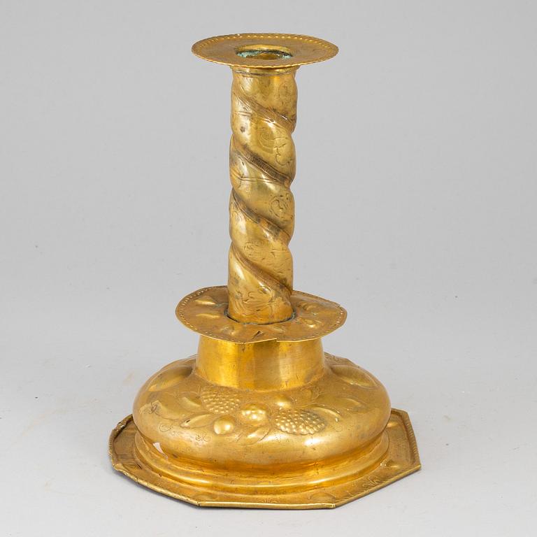 A brass candlestick, 17th/18th century.