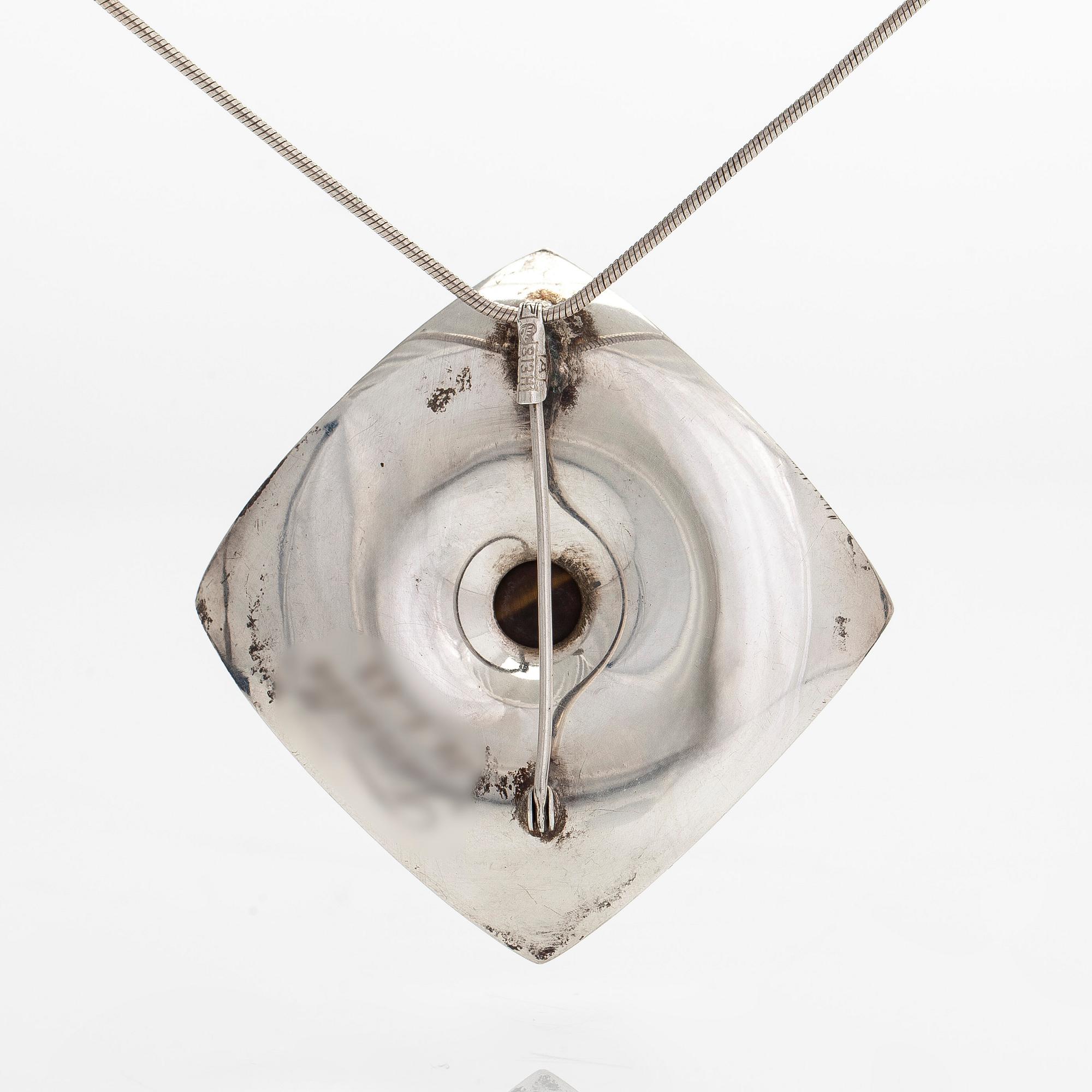 Elis Kauppi, a silver brooch/pendant, and tiger's eye. Kupittaan Kulta, Turku 1962.