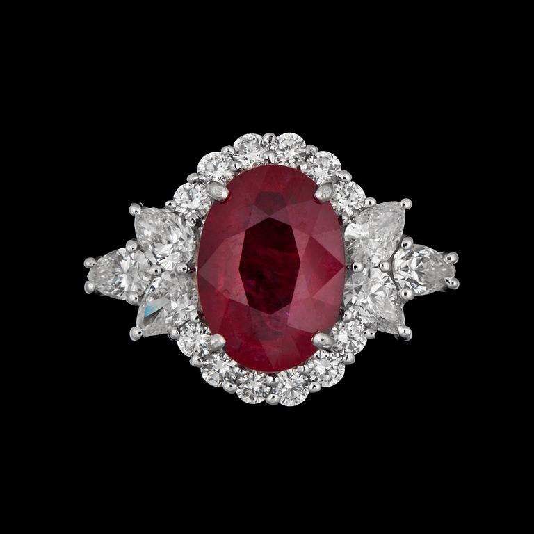 A ruby, app. 4.02 ct. framed by diamonds tot. app. 1.38 cts ring.