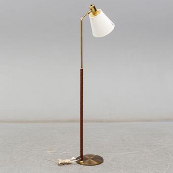 a brass and leather floor lamp from the second half of the 20th century.
