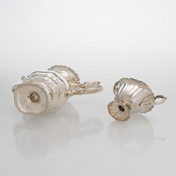 A silver coffee pot, sugar bowl, cream jug, and sugar tongs, Finland 1926-49.