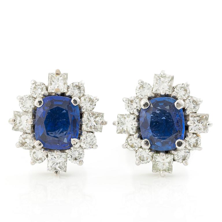 A pair of 14K gold earrings with faceted sapphires and round brilliant- and princess-cut diamonds.