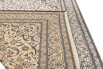 A Nain carpet, part silk, 9 laa, c. 390 x 295 cm.