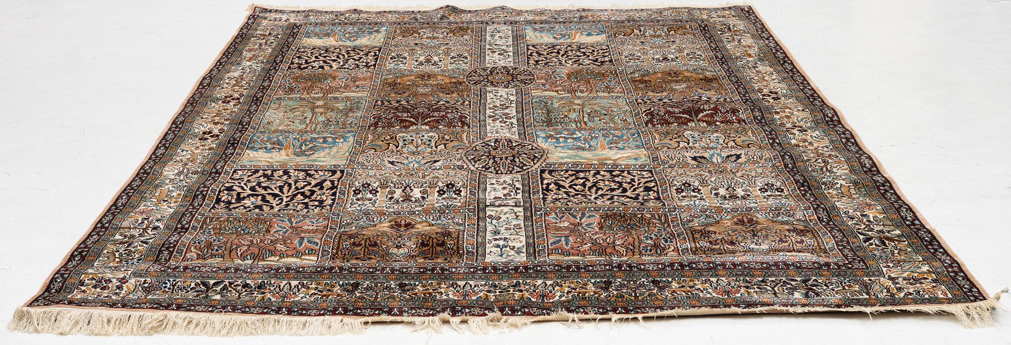 An oriental silk carpet, c. 305 x 205 cm.