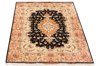 A Tabriz rug, a. 210 x 147 cm.