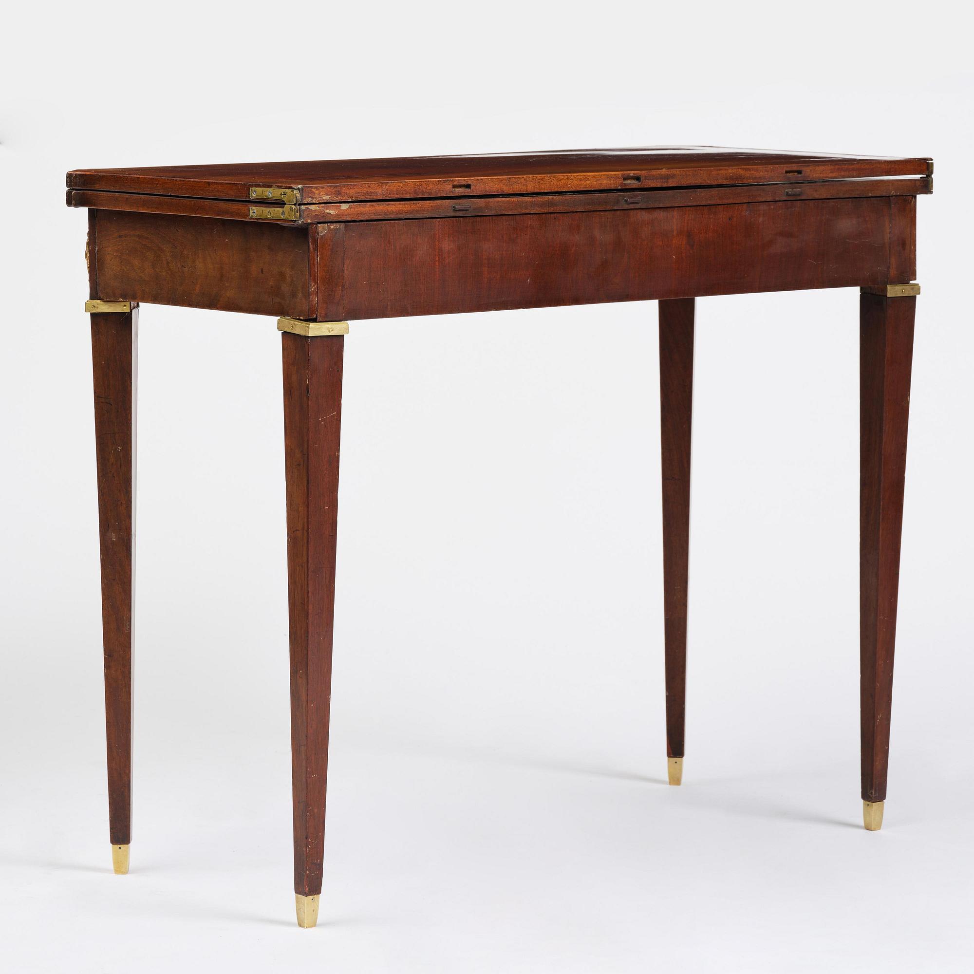 A Gustavian 'concertina action' mahogany games table by Georg Haupt (master in Stockholm 1770-84).