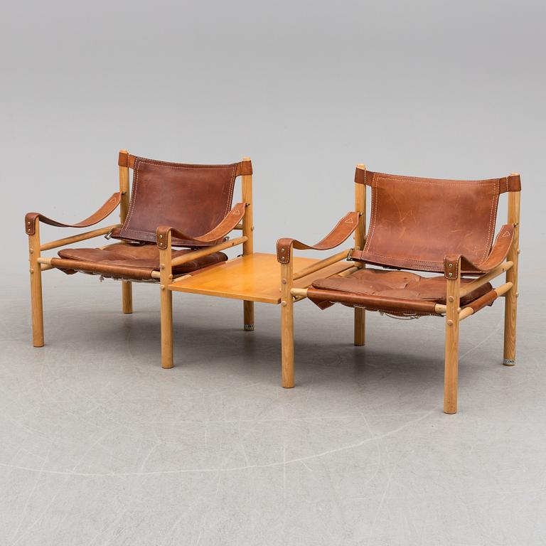 A pair of easy chairs by Arne Norell with a table leaf.