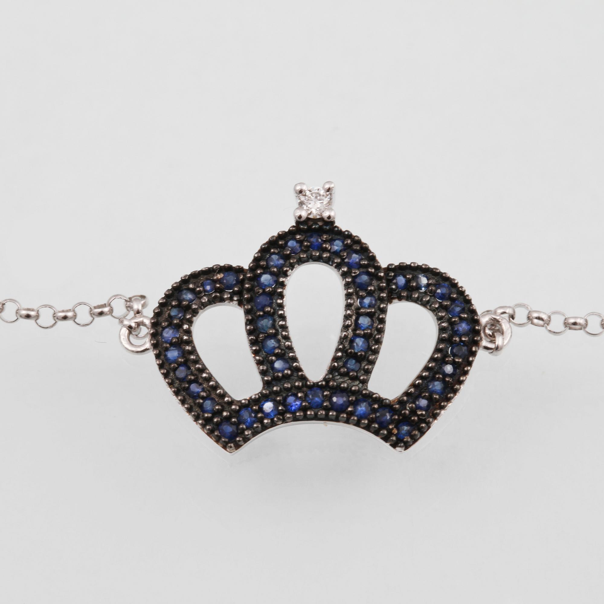 ARMBAND, 18K vitguld med briljantslipad diamant ca 0.02 ct samt fasettslipade safirer ca 0.19 ct. Vikt 1,8 gram.