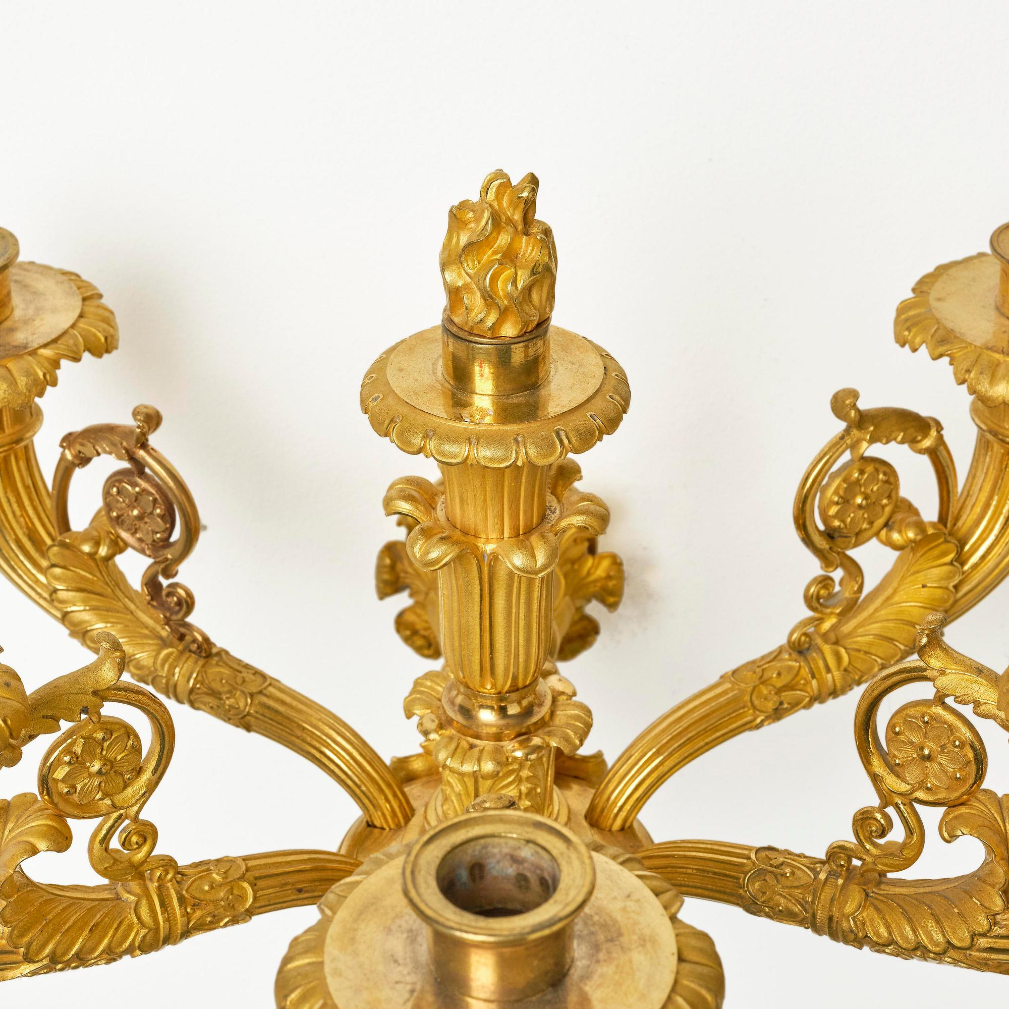 A pair of French Empire six-branch ormolu appliques, ca 1820's.