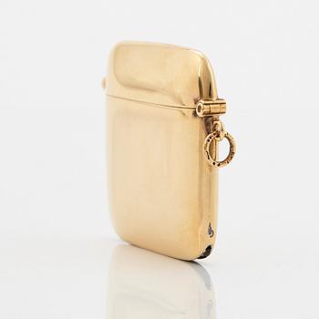 An 18K gold match case/pendant set with a faceted sapphire.
