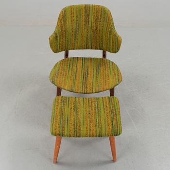 An IKEA armchair with a stool.