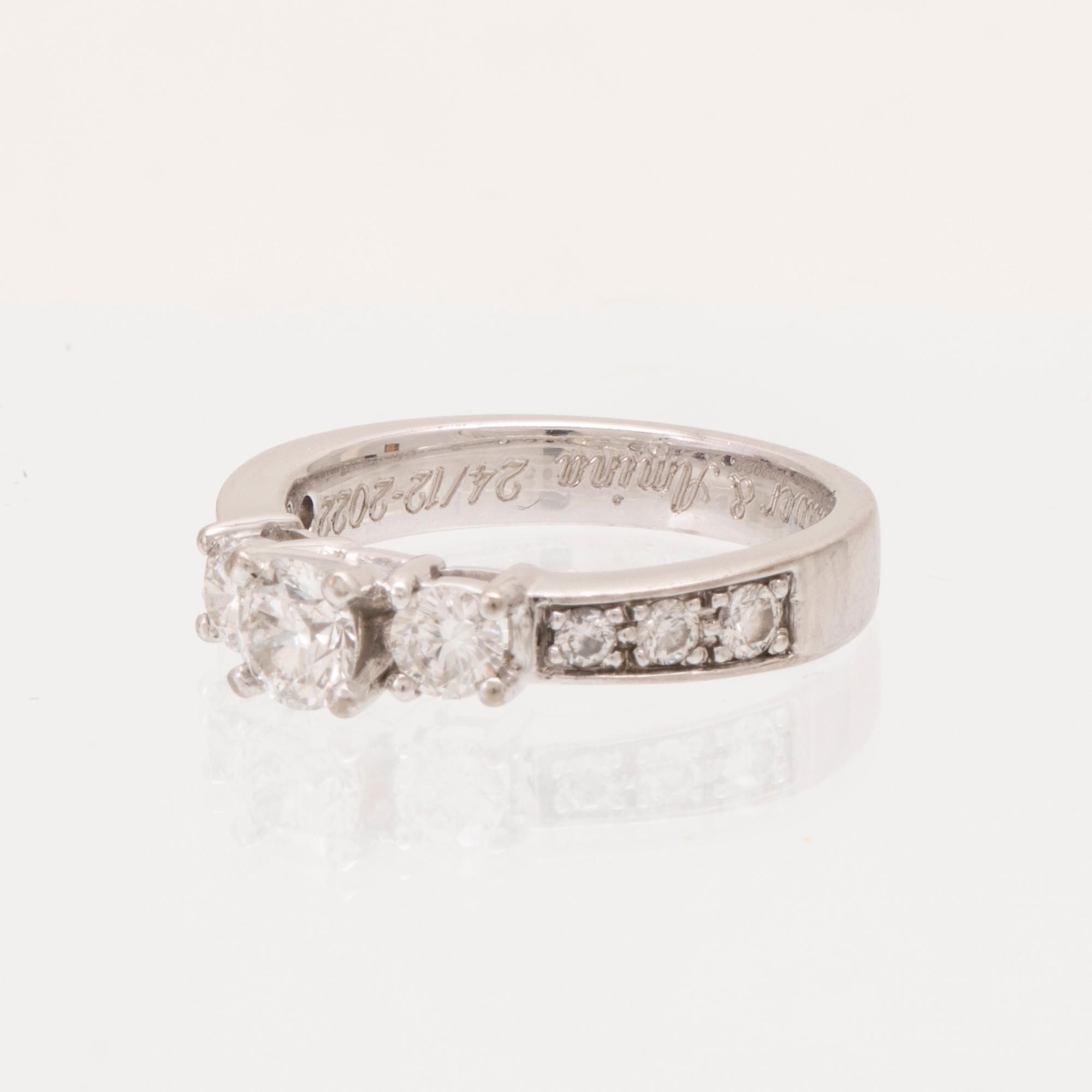 An 18K white gold ring set with round brilliant cut diamonds.