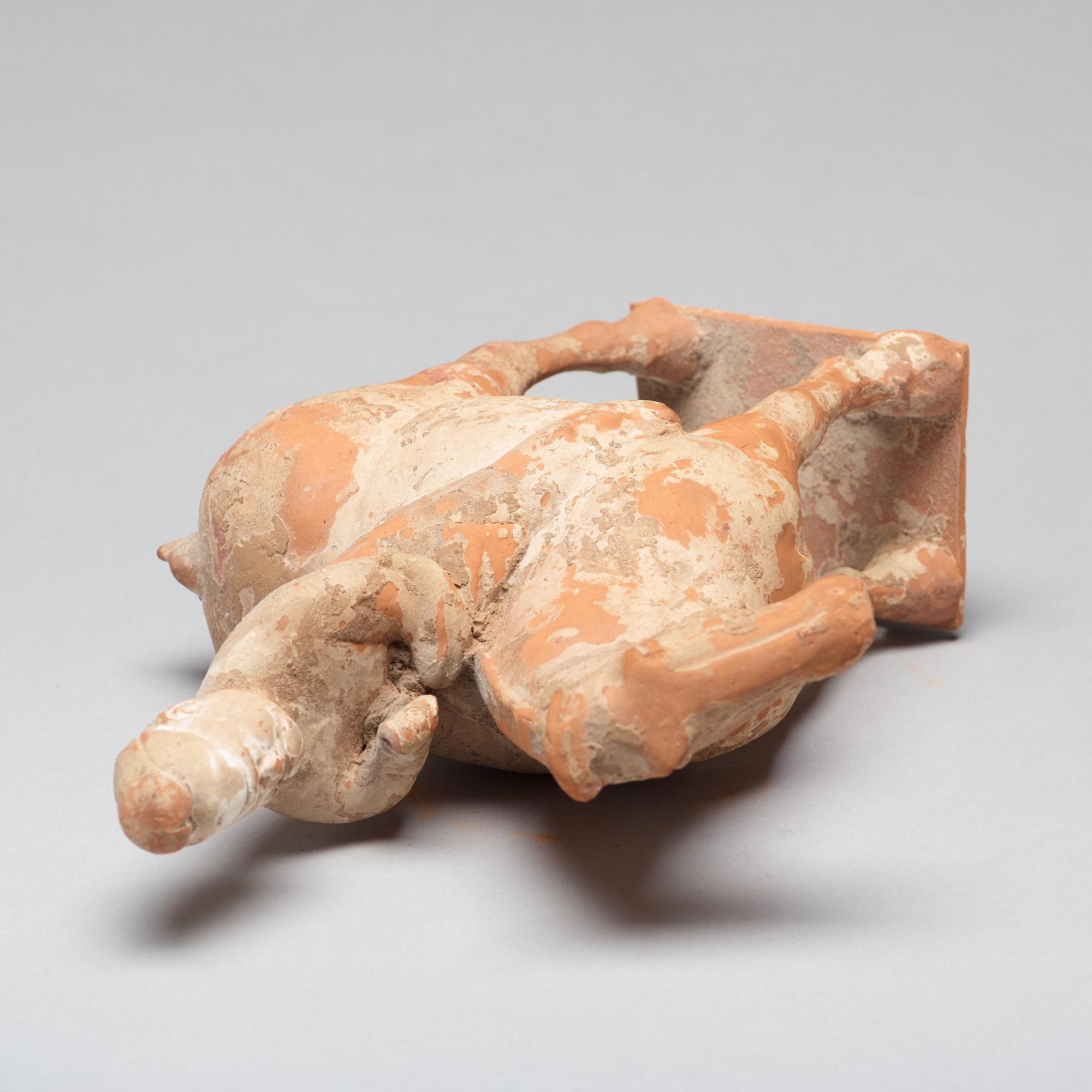 A painted pottery figure of an equestrian standard-bearer, Tang dynasty (618-907 AD.).