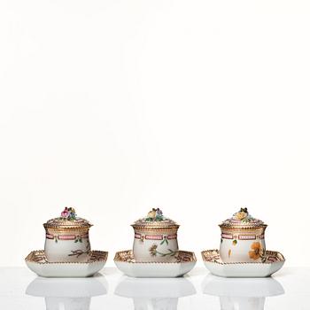 A set of 12 Royal Copenhagen 'Flora Danica' custard cups with covers and stands, Denmark, 20th Century.