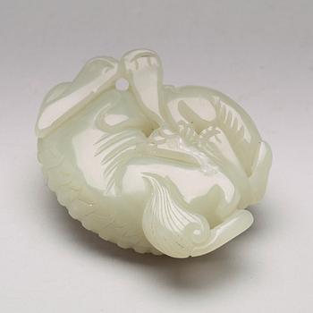 A Chinese nephrite figure of a reclining buddhist lion and its cub, presumably circa 1900.