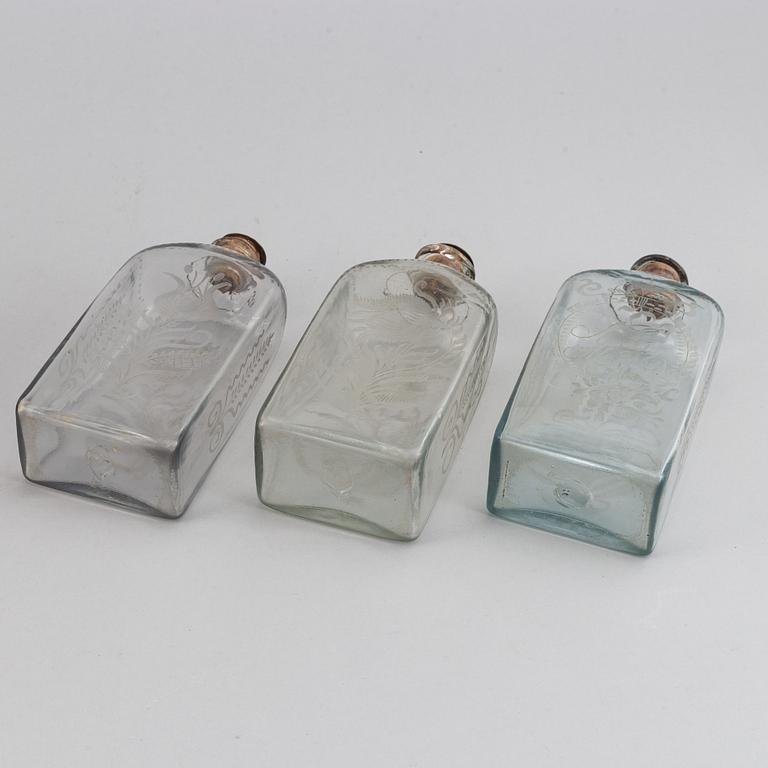 A late Empire mahogany box with three glass bottles, mid 19th Century.