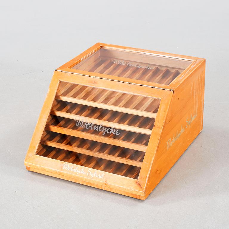 A wooden box with glass for spools of thread, mid 20th century.