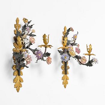 A pair of French Louis XV-style gilt bronze and porcelain two-branch appliques, 19th century.