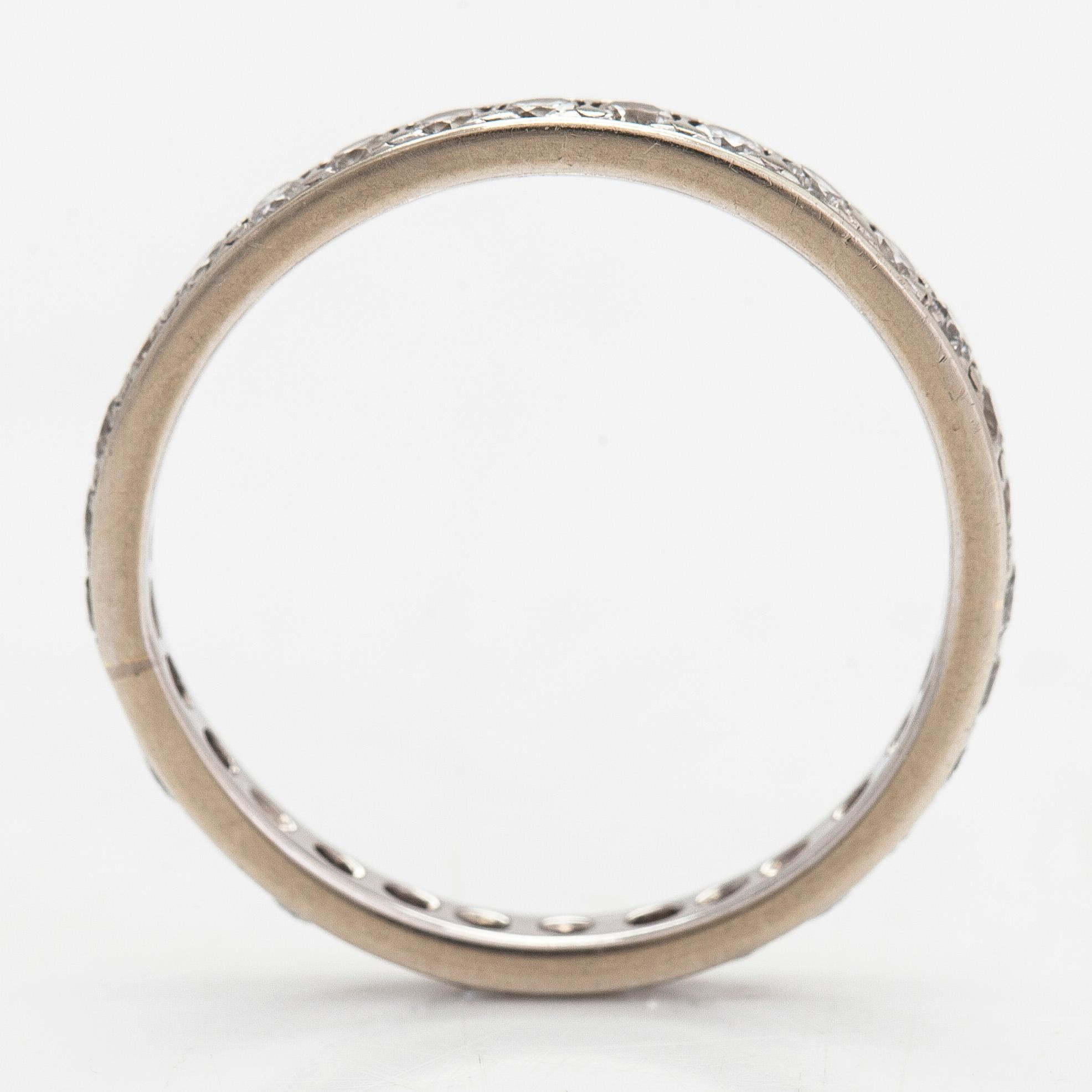 An 18K white gold eternity ring with brilliant-cut diamonds totalling approximately 0.60 ct.