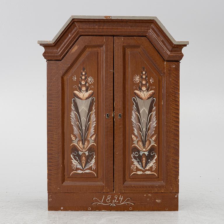 A cabinet, dated 1824.