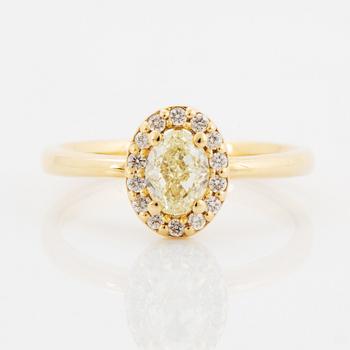 Oval light yellow diamond and brilliant-cut diamond ring.
