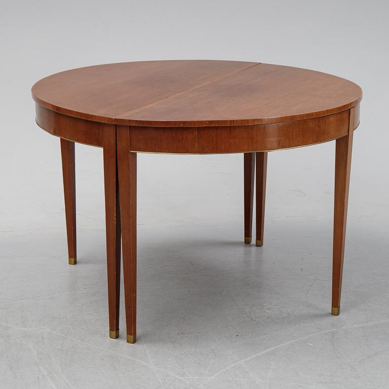 A late Gustavian style mahogany dining table in two parts, ca 1900.