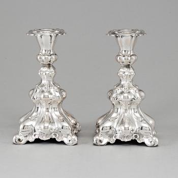 A pair of silver candle sticks.