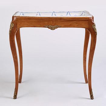 A rococo faience-top tea table, Rörstrand 1765.