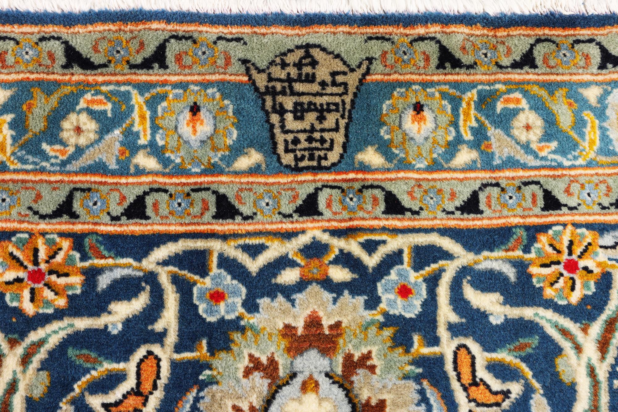 A Kashan carpet, signed Isfahanian, a. 407 x 310 cm.