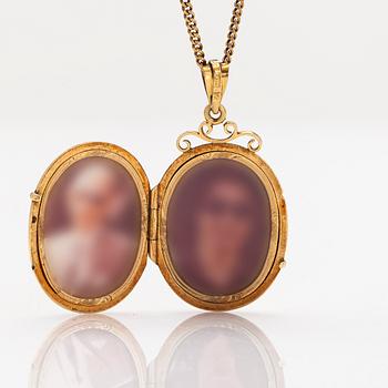 An 18K gold locket pendant, with chain in 14K gold.