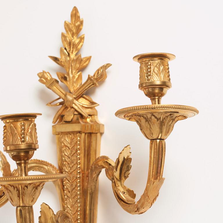 A pair of Louis XVI late 18th century gilt bronze three-light wall-lights.