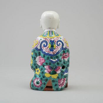 A porcelain figure of a laughing boy, Qing dynasty, 19th Century.