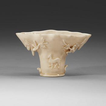 A blanc de chine rhinoserous libation cup, Qing dynasty, Kangxi (1662-1722).