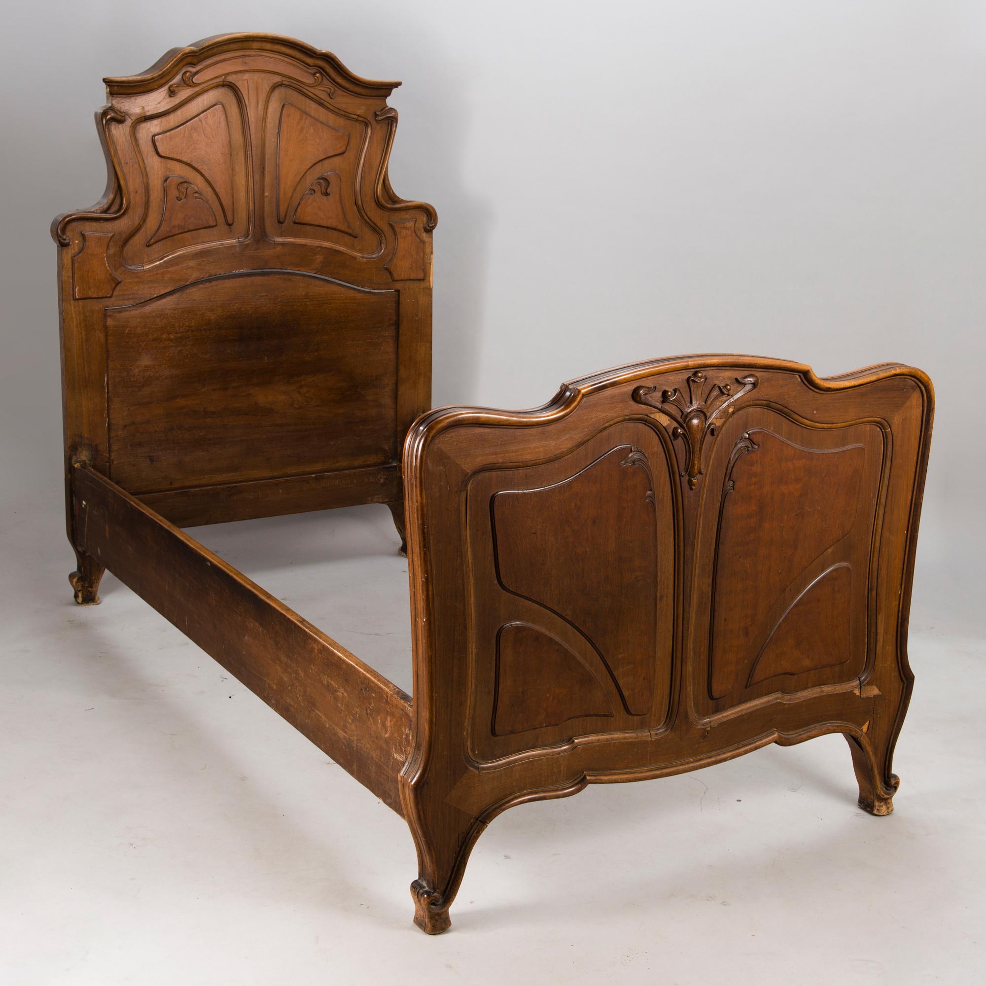 A pair of early 20th Century art nouveau style beds.