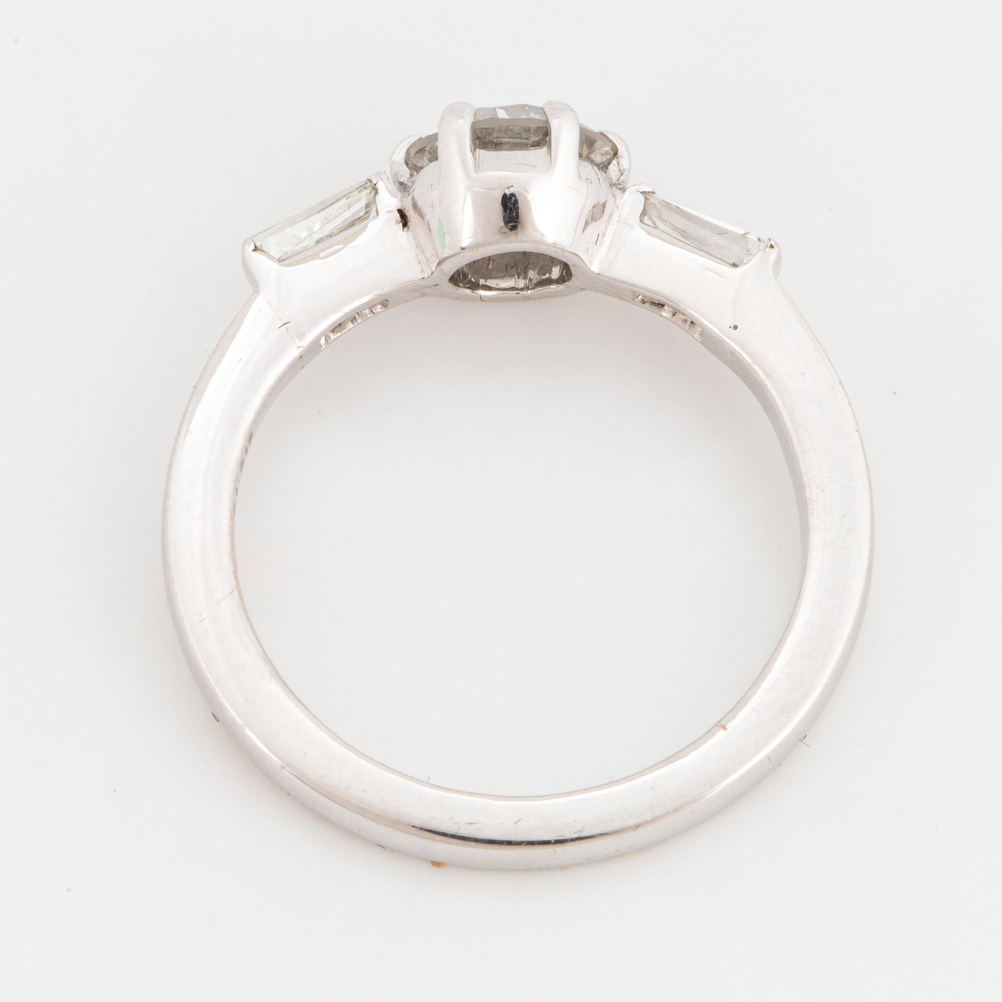 A 14K gold ring set with a round brilliant-cut diamond.