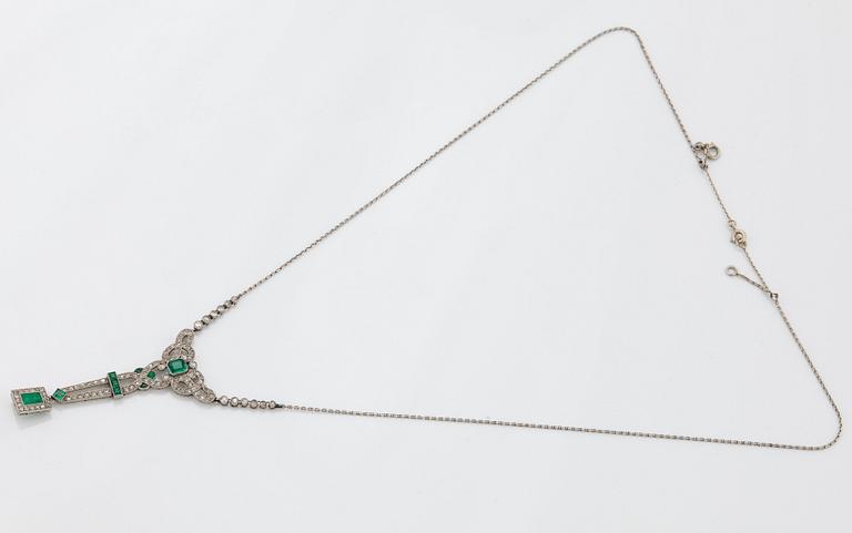 A platinum necklace set with faceted emeralds and old- and eight-cut diamonds.