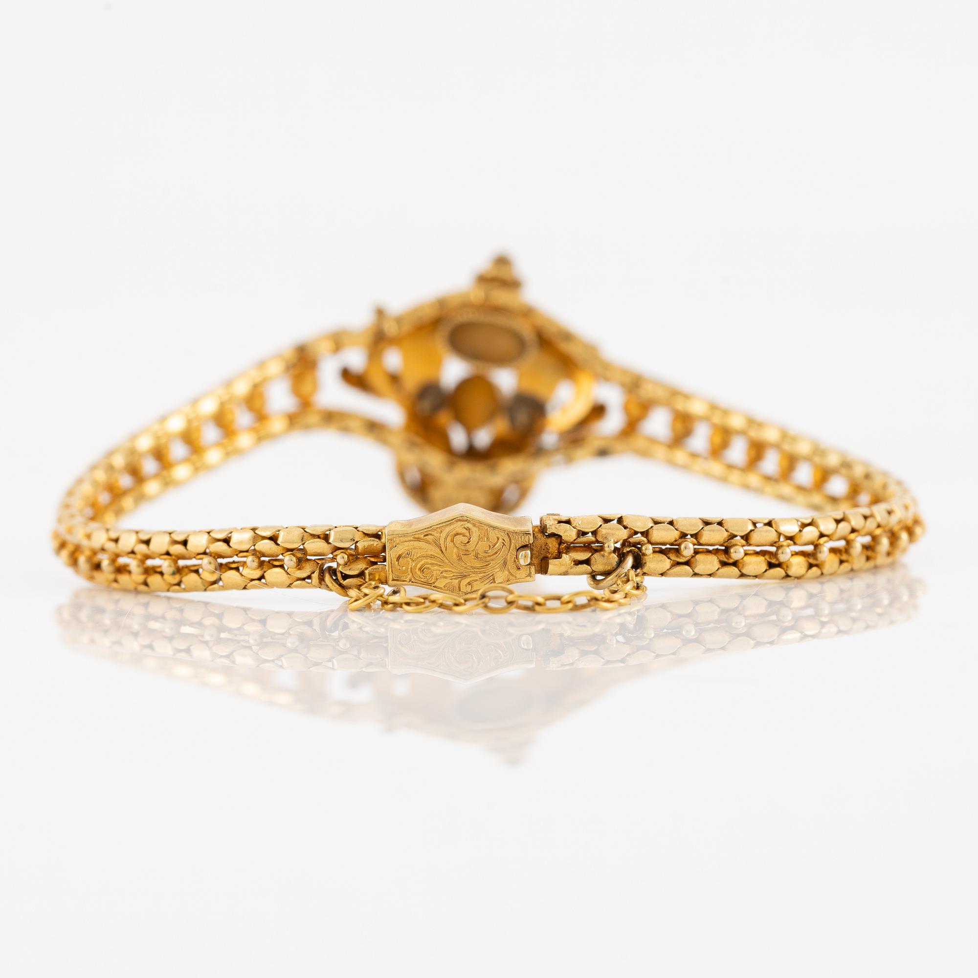 Bracelet, gilded metal with paste stones and enamel.