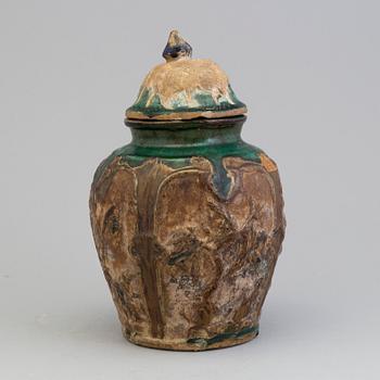 A Chinese 'Shiwan' ware pottery jar with cover, Qing dynasty, 19th century.