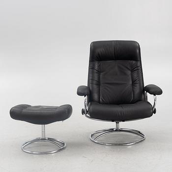 A "Stressless" armchair with ottoman, Ekornes Möbler, Norway, lend of the 20th century.