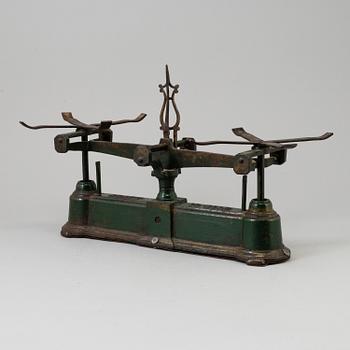 A 20th century cast iron balance with brass and iron weights, partly Skultuna, Sweden.