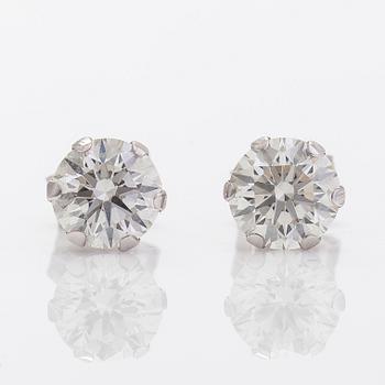 A pair of 14K gold earrings with brilliant cut diamonds.