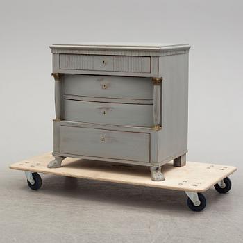 An empire style chest of drawers from around year 1900.